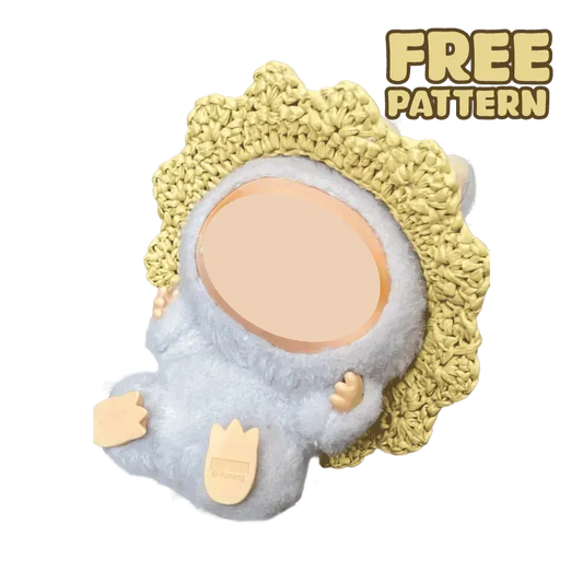 Free crochet straw hat pattern displayed on a plush doll with a yellow crocheted hat and black background
