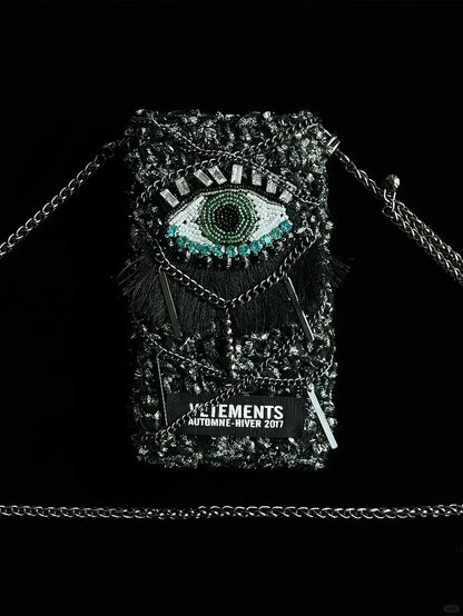 FREE｜cyberpunk crochet phone bag pattern featuring a detailed eye design with black chain strap