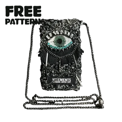 FREE｜cyberpunk crochet phone bag pattern featuring a black crochet design with an eye motif and metallic chain strap