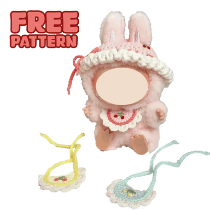 Cute plush doll wearing colorful crochet hat and pink overalls with FREE|plush toy hat and bib crochet tutorial