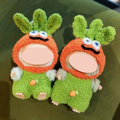 Two plush dolls wearing fun crochet costume patterns with carrot-themed hats and green outfits