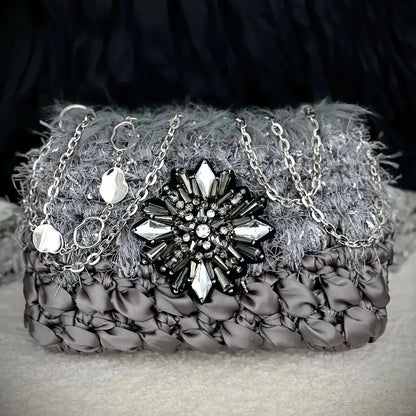 Galactic inspired purse pattern crochet diagram featuring a textured gray purse with silver chain and gemstone brooch