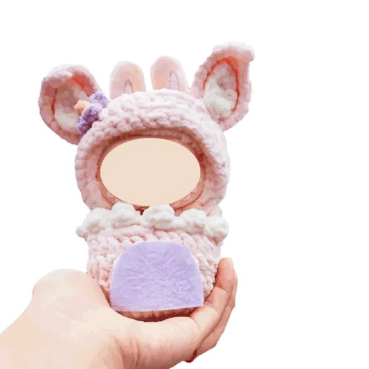 Cupcake doll pouch crochet pattern 17cm in soft pastel pink and purple held in hand with bunny ears