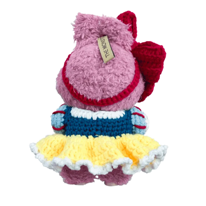 Back view of a handmade pink plush doll wearing a crocheted dress from 17cm collectible doll clothes pattern