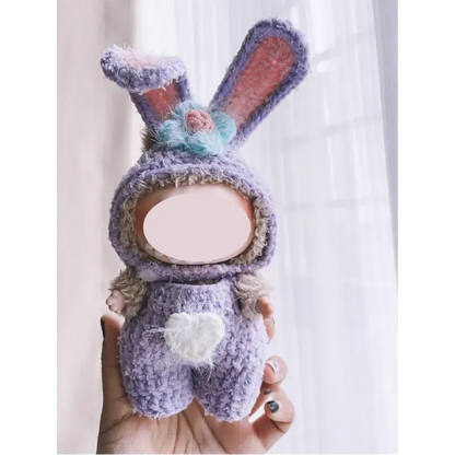 Hand holding a purple bunny outfit doll made with collectible crochet dolls pattern by The Knit Krazy