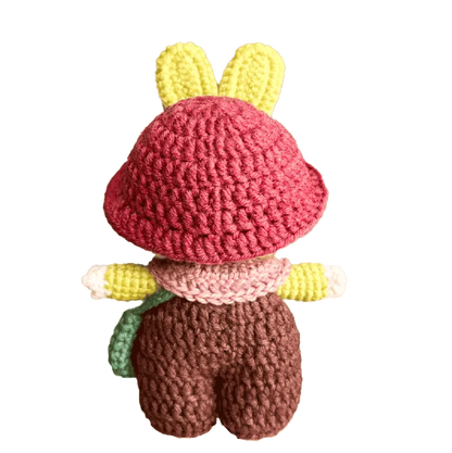 Handmade crochet bunny doll with pink hat yellow ears and brown pants by The Knit Krazy