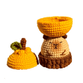 Handcrafted crochet capybara storage box pattern with removable lid in warm yellow and brown tones
