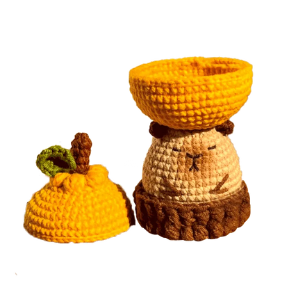 Handcrafted crochet capybara storage box pattern with removable lid in warm yellow and brown tones
