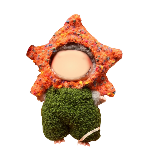 Crochet doll wearing a handmade green and orange outfit from crochet doll outfit pattern by redbook