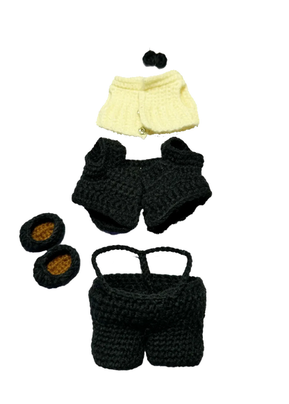 Handmade black and cream crochet doll wedding pattern clothing pieces on black background