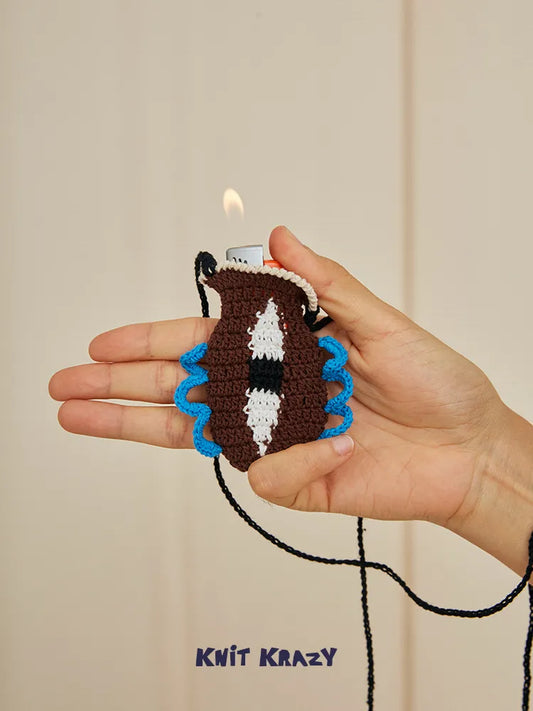 Hand holding Handmade Crochet Vase Pouch Pendant Mini Sculpture Bag for Vape and Lipstick with wick lit