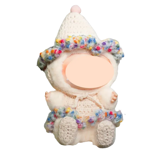 Cute crochet doll clothes including a colorful ruffled hat and skirt on a plush doll from The Knit Krazy