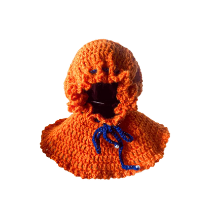 Handmade orange crocheted hoodie shown as a DIY Halloween doll costume with blue tie string