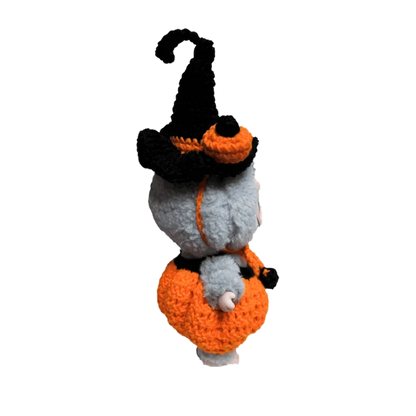 Handcrafted doll wearing a crocheted pumpkin costume pattern for dolls with a black witch hat