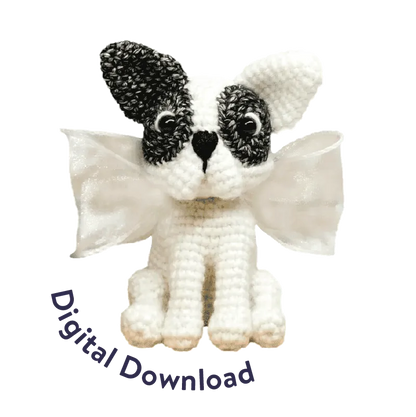 Crochet French bulldog pattern amigurumi with black and white yarn and decorative wings
