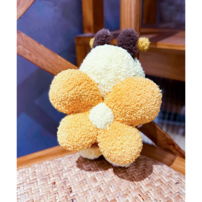 Back view of playful bee knitwear for dolls featuring soft textured yellow and brown yarn wings and antennae
