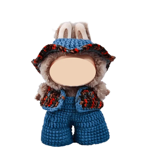 17cm plush doll wearing handmade blue crochet overalls and a matching hat from 17cm plush doll crochet clothes tutorial