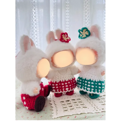 Three plush dolls wearing crocheted dresses featuring sweetheart doll outfit pattern by redbook