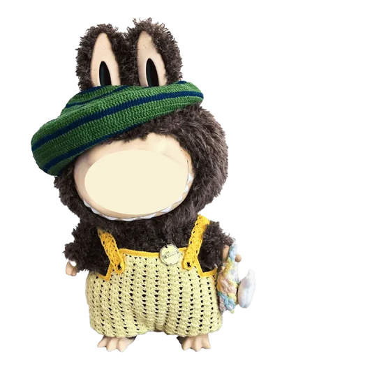 Hand holding a black and white crocheted bird hat made with the Zimomo crochet outfit pattern