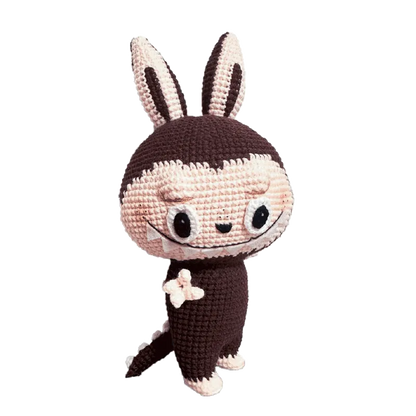 Zimomo inspired crochet pattern featuring a cute crocheted bunny-like character with large ears and expressive eyes